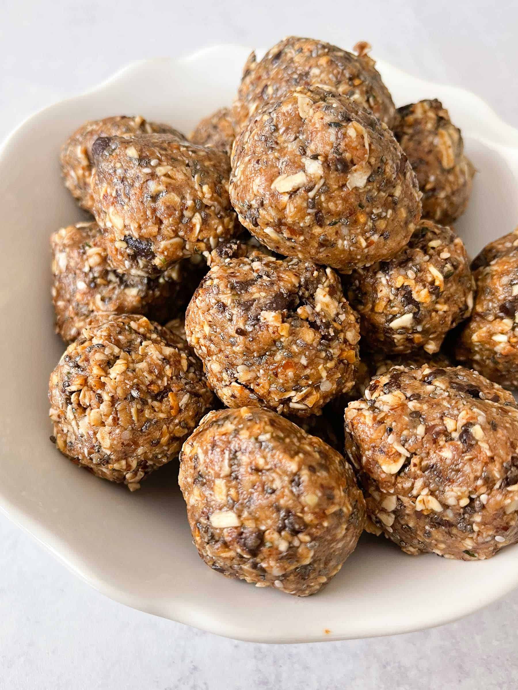 energy bites aka no bake cookie balls in a white bowl with a white background