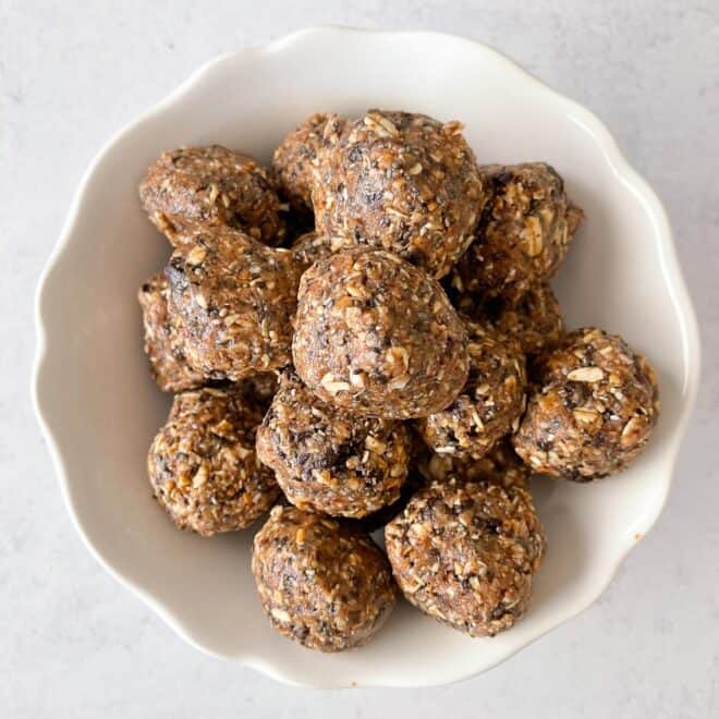 cookie balls stacked on a white plate