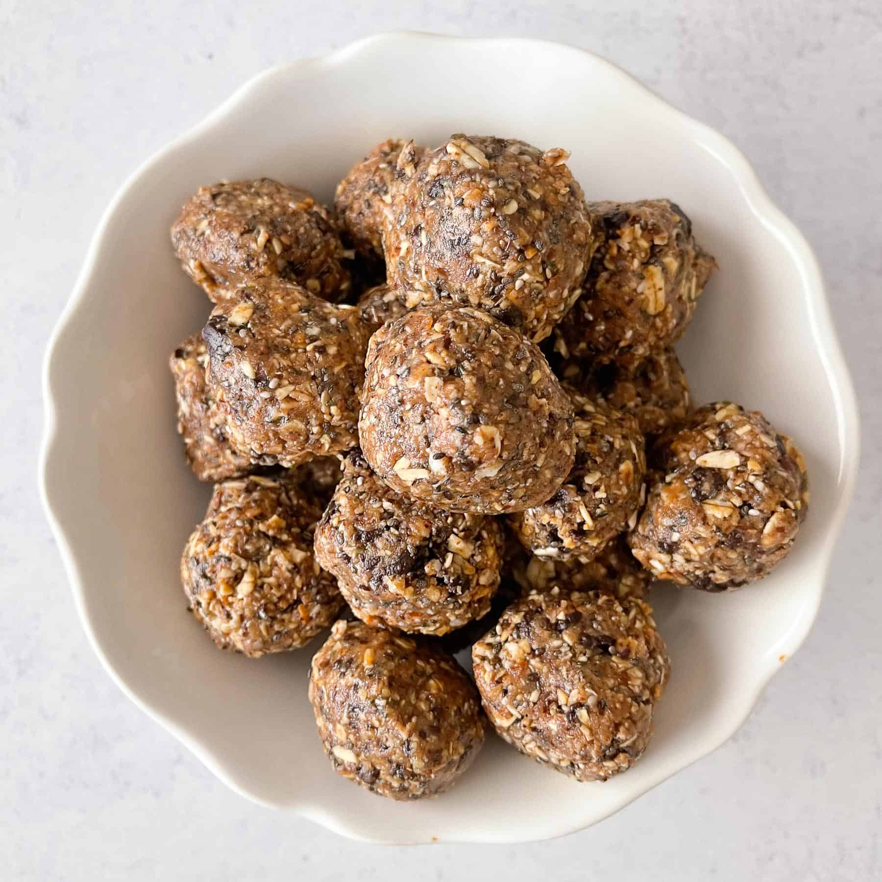 energy bites aka no bake cookie balls in a white bowl with a white background