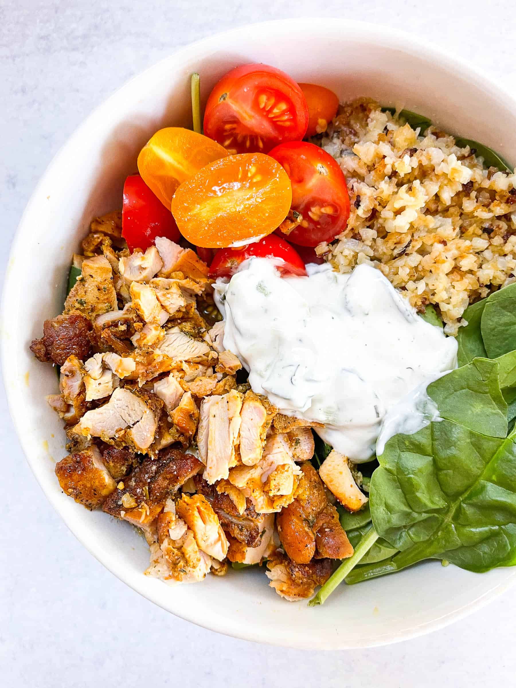 keto sheet pan chicken shawarma bowls in a white bowl with a white background