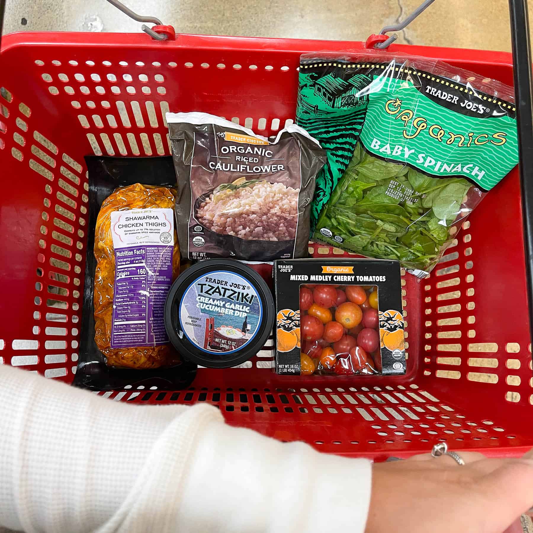 ingredients for keto sheet pan chicken shawarma bowls in a red trader joe's basket