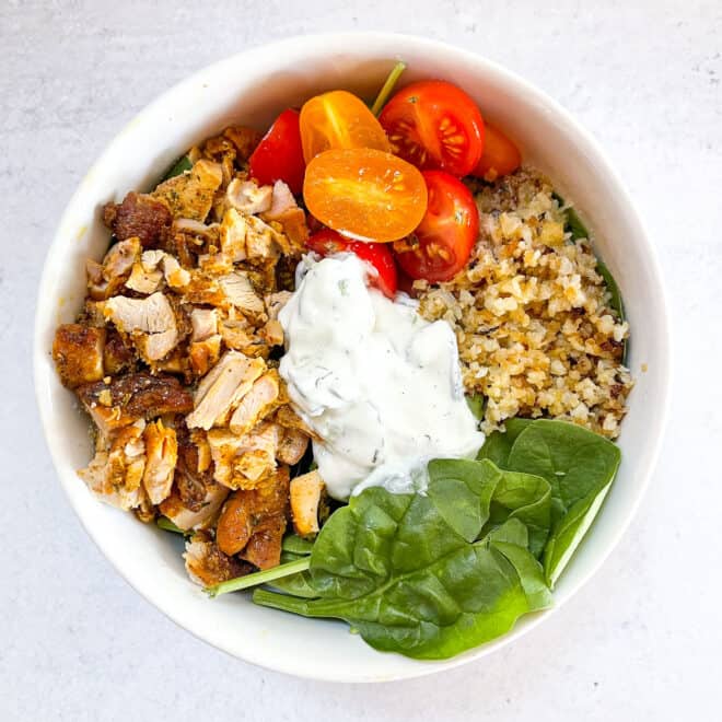 keto sheet pan chicken shawarma bowls in a white bowl with a white background