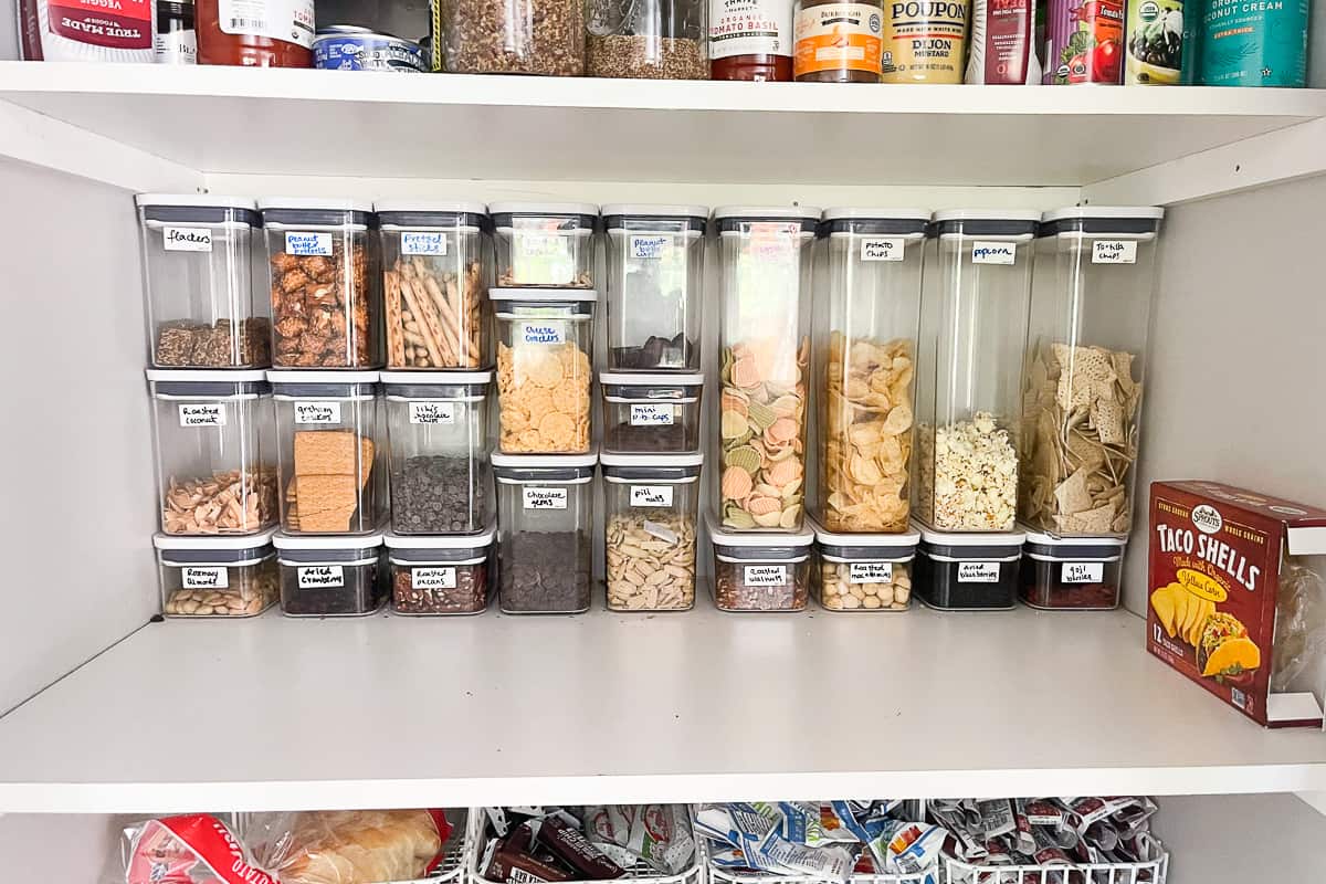 oxo pop containers stacked and filled with food in an organized pantry