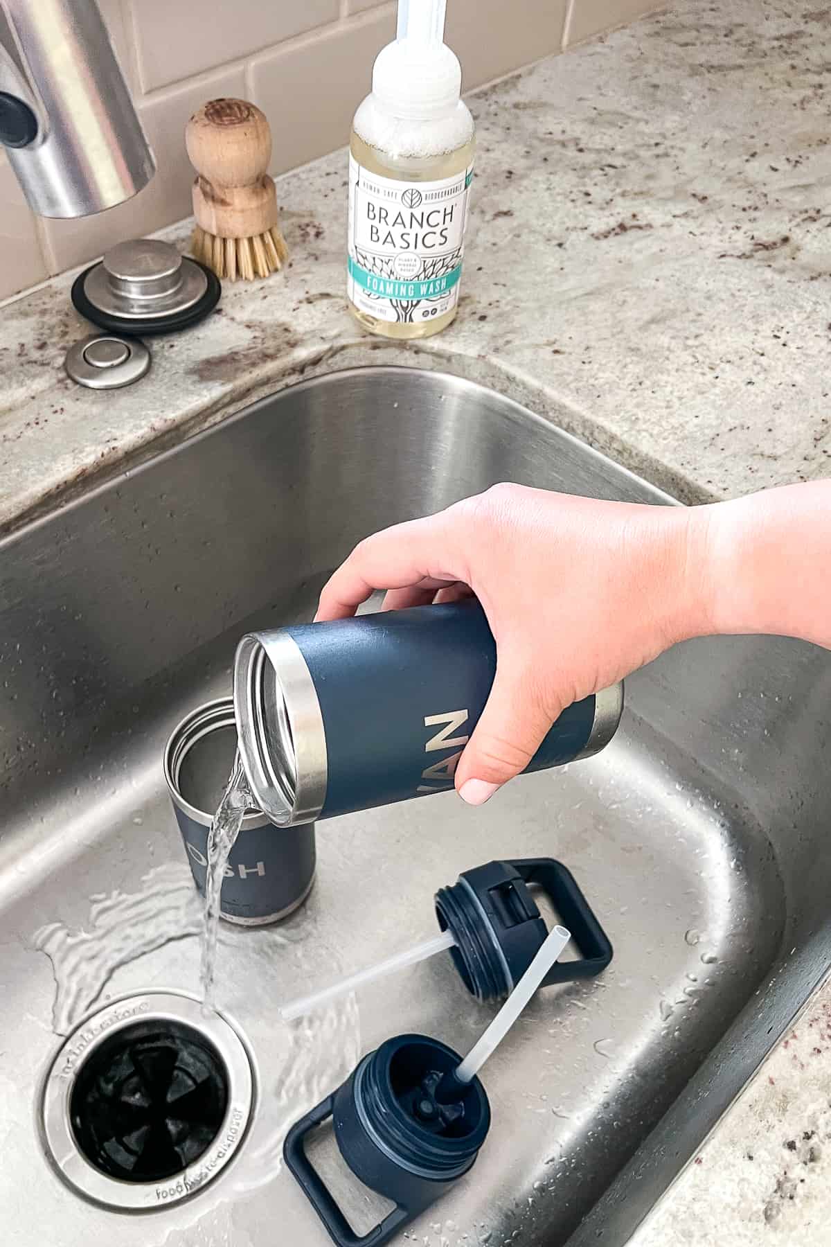 pouring water from reusable water bottle
