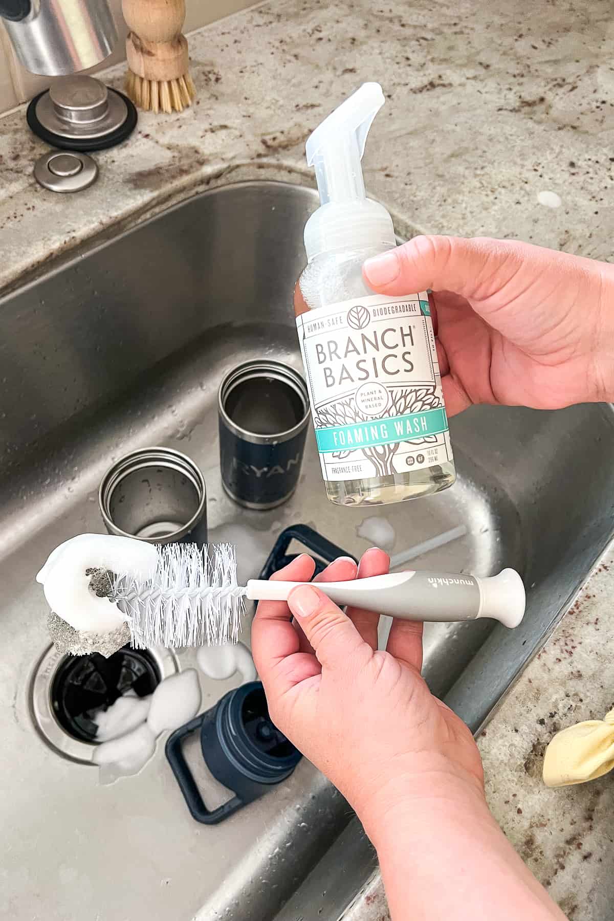 adding foaming soap to bottle brush