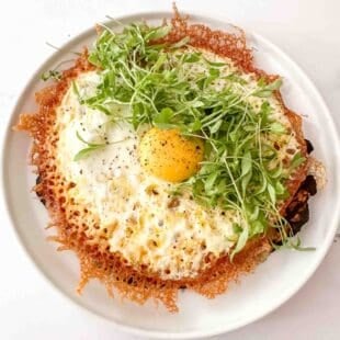 over head shot of a flat egg taco topped with microgreens