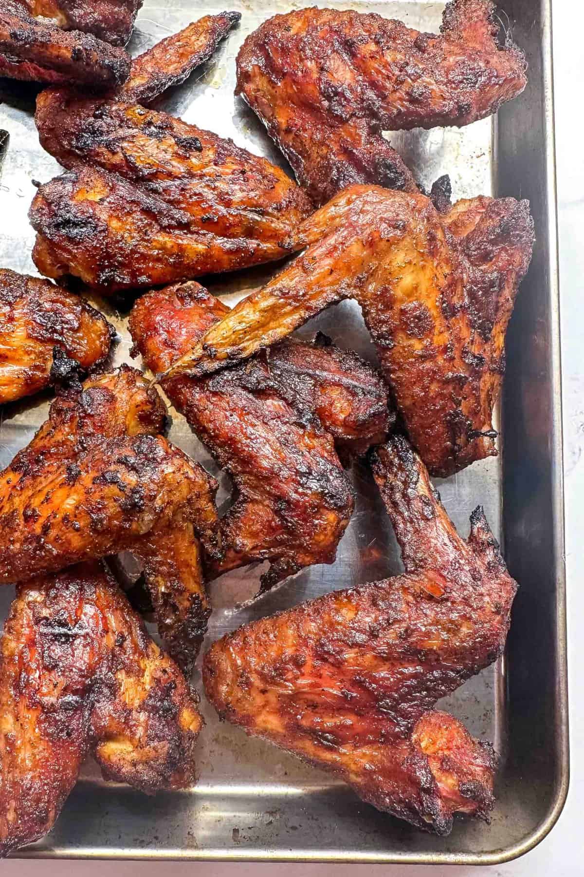 a close up of smoked chicken wings with a sweet and savory dry rub