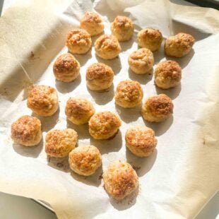 a photo of chicken meatballs on a lined baking sheet