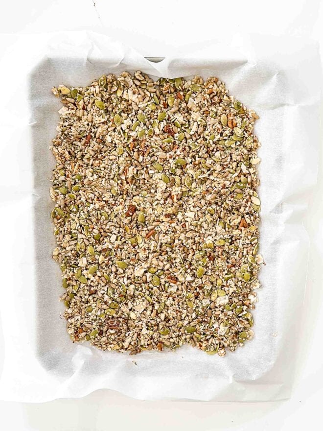 granola spread out on a baking sheet 