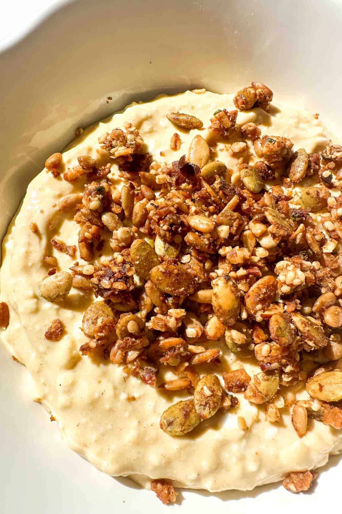 protein cheesecake filling in a bowl topped with granola 
