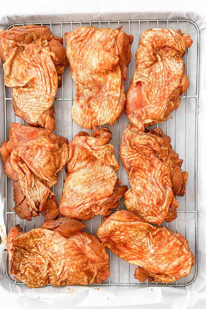 marinated chicken thighs on a wire rack