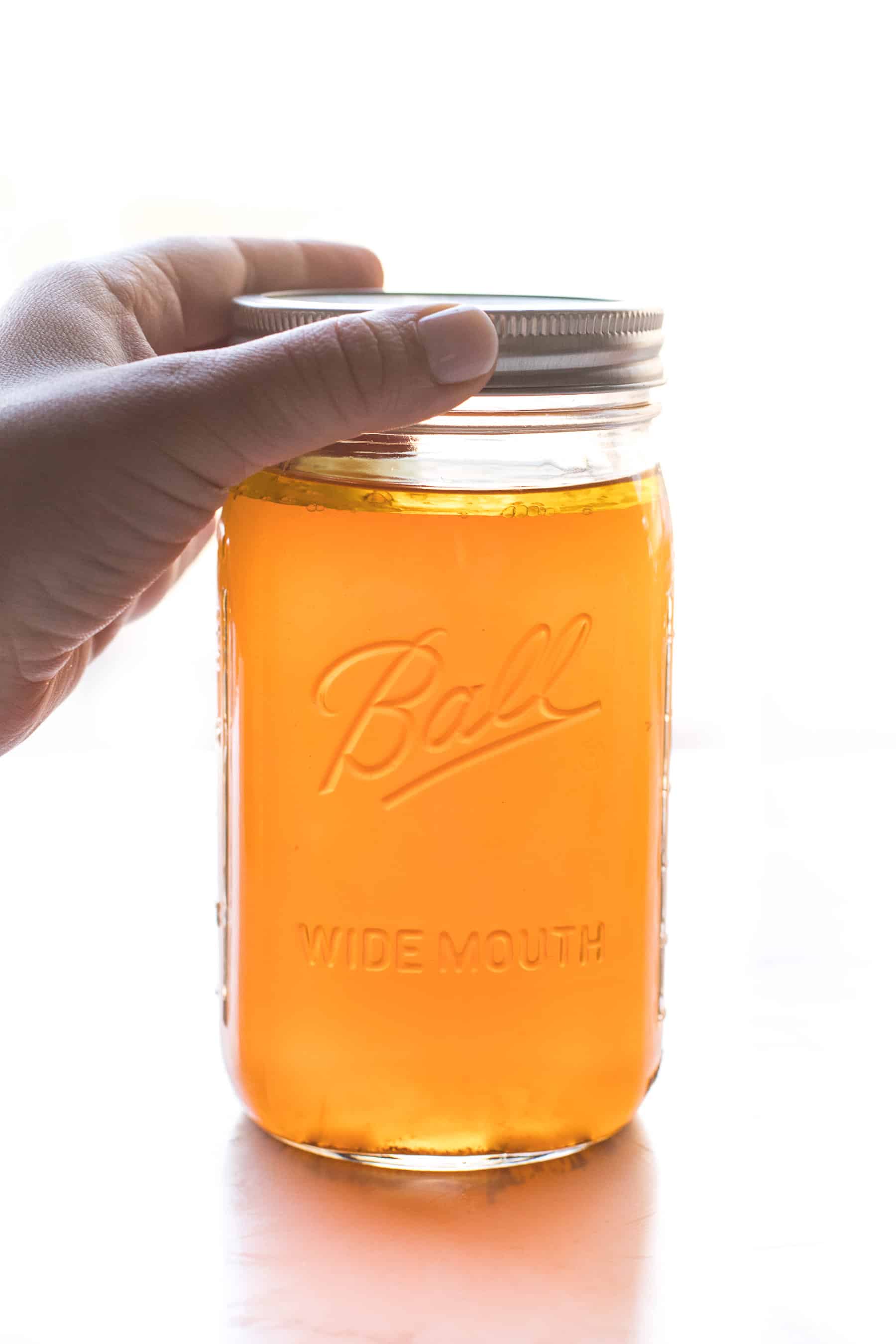 a mason jar filled with bone broth