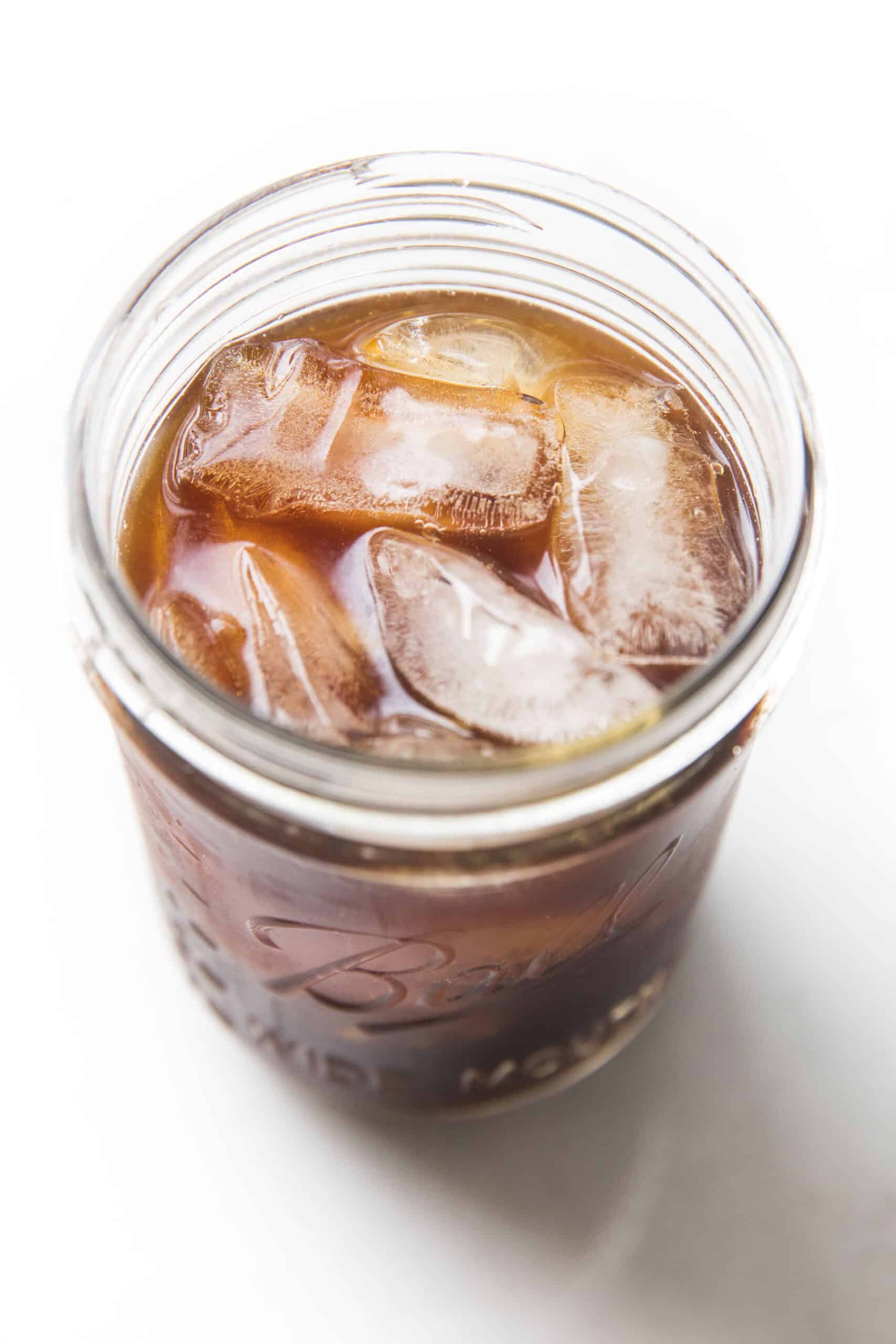 cold brew coffee over ice in a mason jar