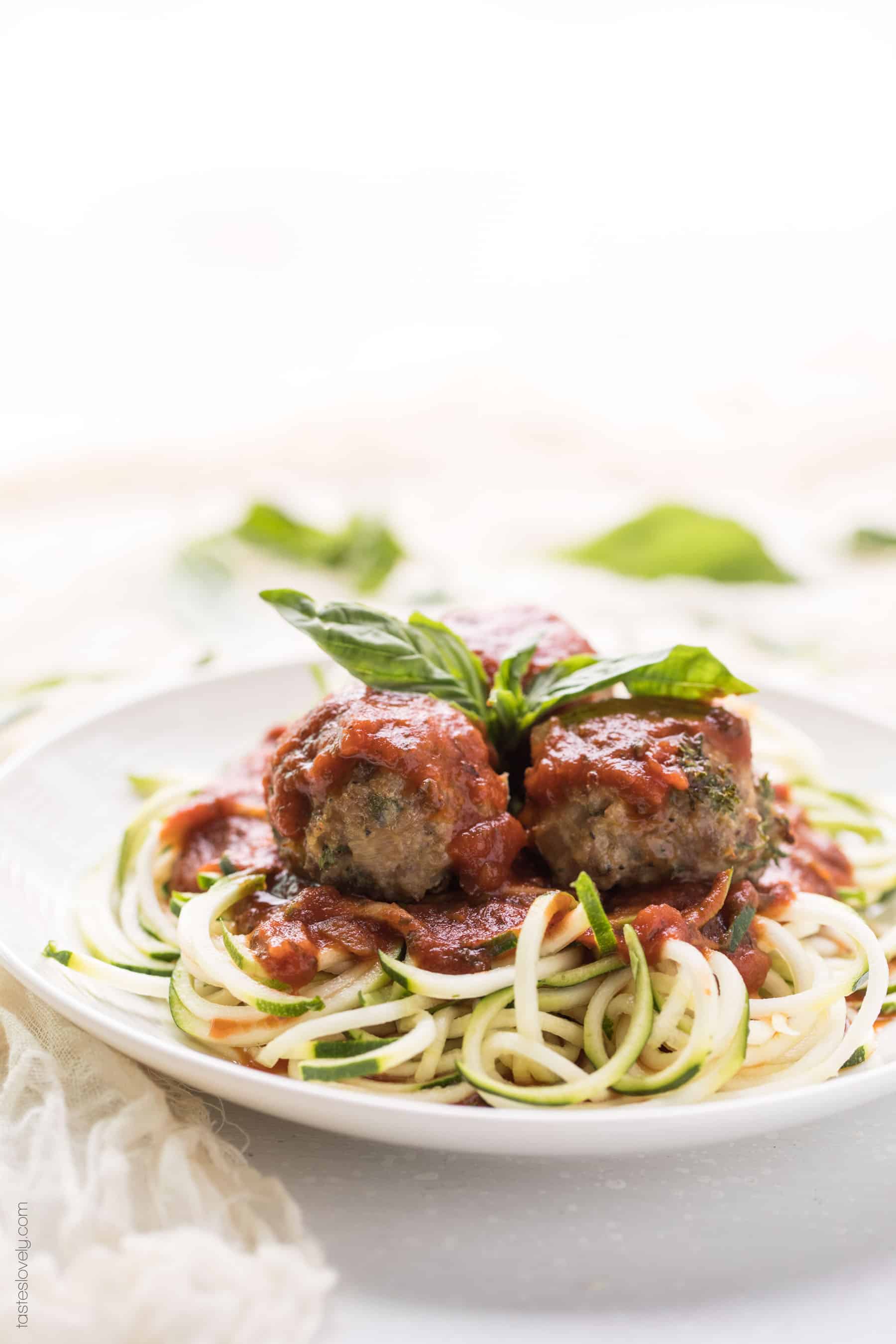 keto meatballs recipe on a plate with sauce and zucchini noodles