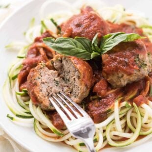 a fork cutting into a meatball made without breadcrumbs