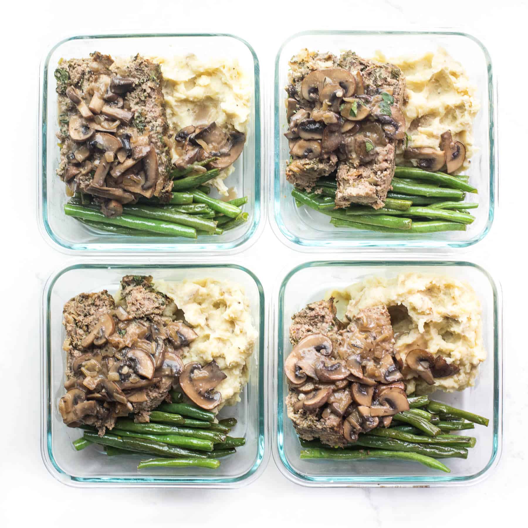 meal prep containers with meatloaf, mashed potatoes and green beans