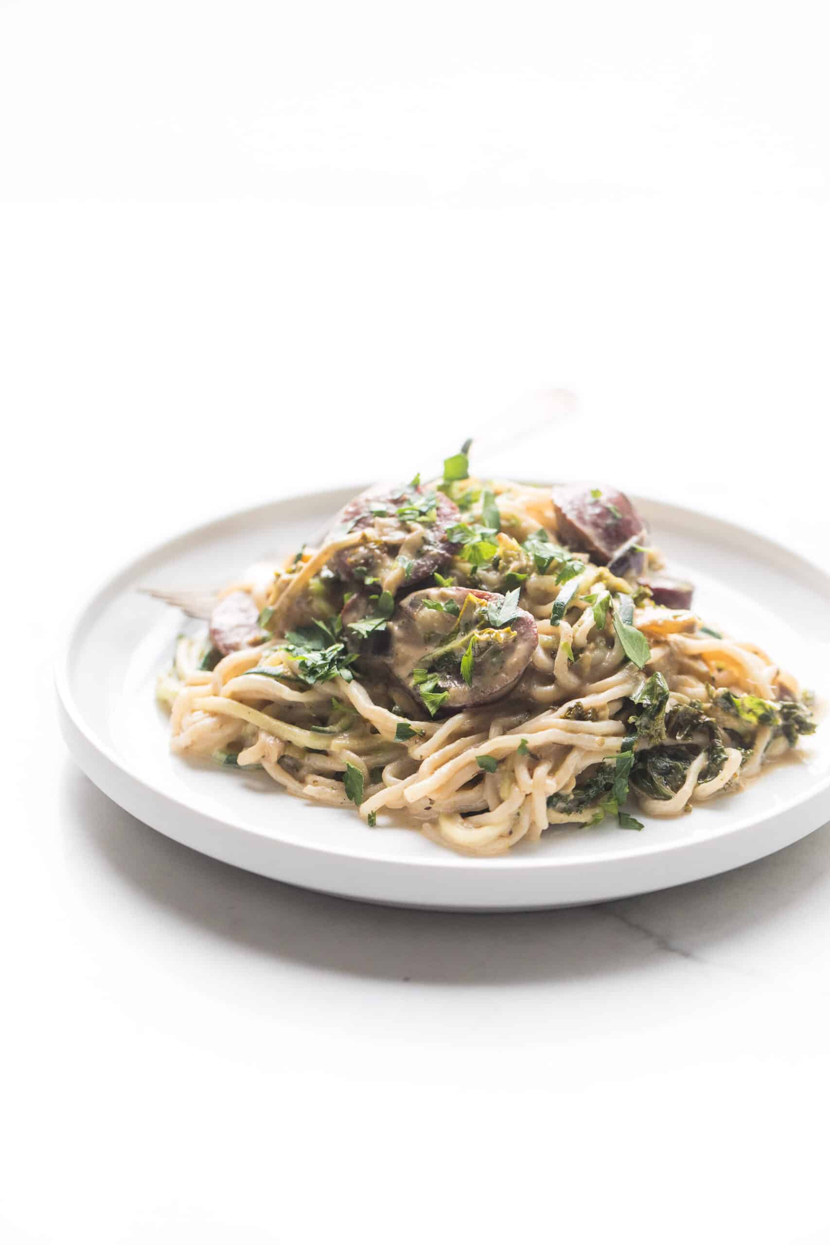 creamy pasta on a white plate and white background