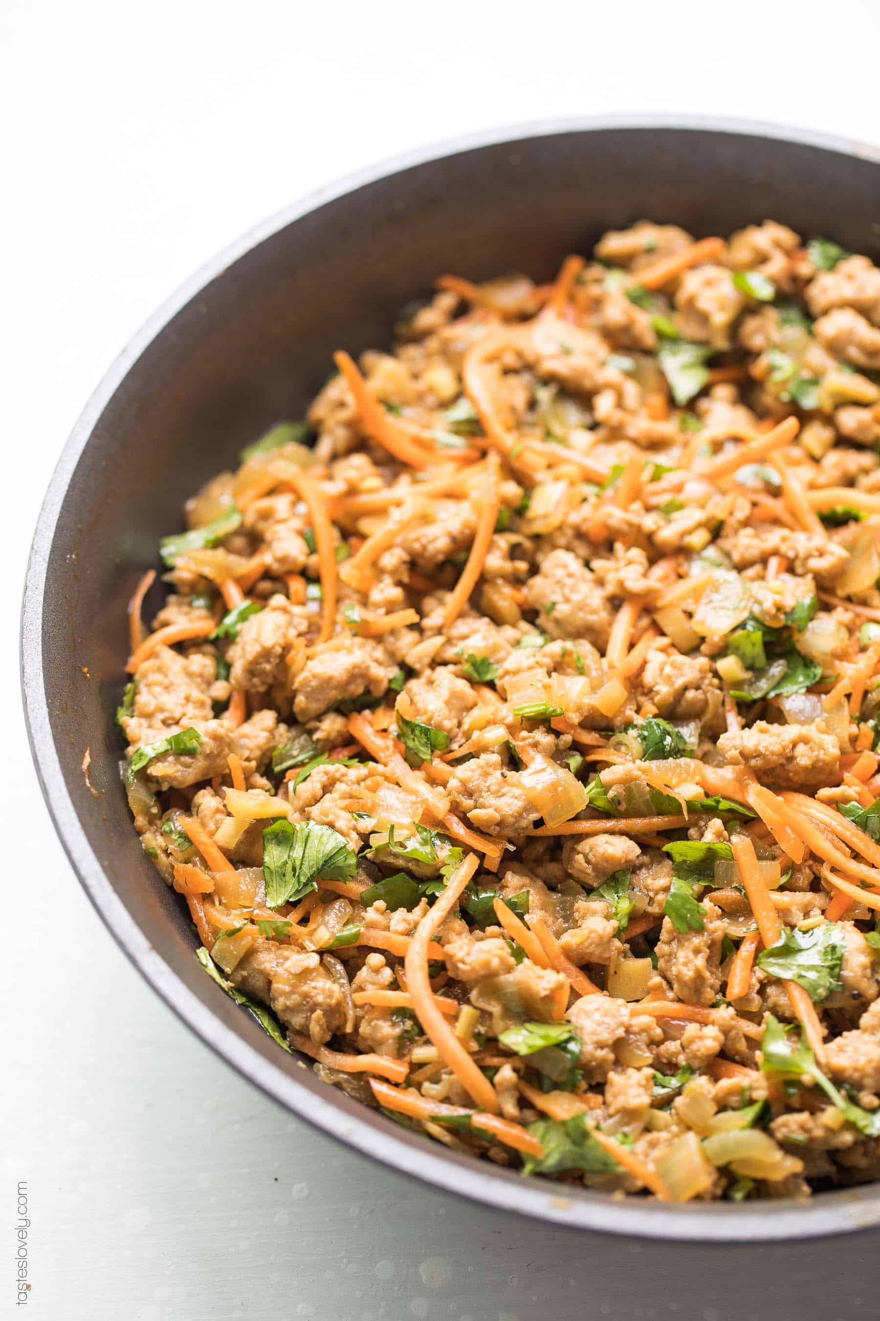 Paleo + Whole30 Thai Chicken Lettuce Wraps - a quick and healthy dinner recipe with ground chicken, sauteed onions, a thai sauce, cilantro and shredded carrots. Topped with a bright and fresh herby green dressing and cashews. #paleo #whole30 #glutenfree #grainfree #dairyfree #sugarfree #keto #cleaneating #realfood