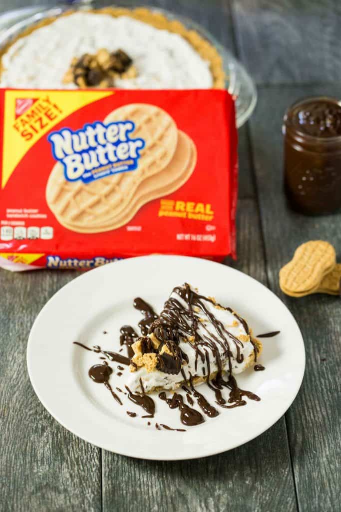 Peanut Butter Lovers Ice Cream Pie - a no bake dessert with a NUTTER BUTTER crust, vanilla and peanut butter cup ice cream filling, and a peanut butter chocolate sauce drizzled on top