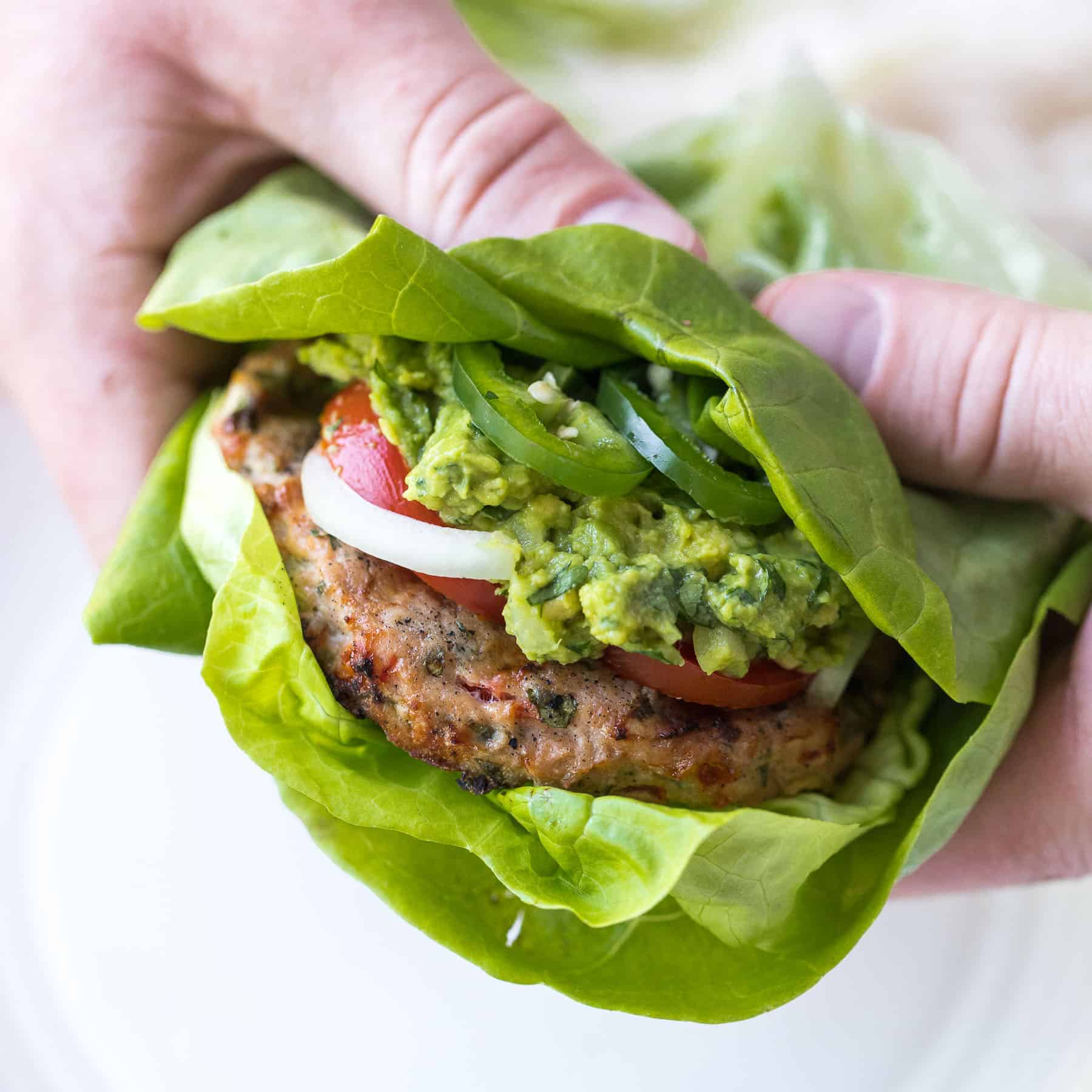 a mexican-inspired turkey burger in a butter lettuce wrap