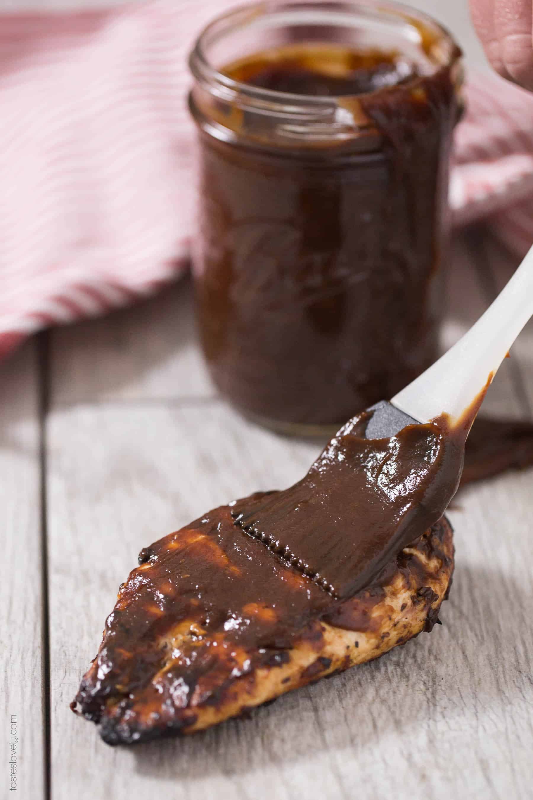 brushing bbq sauce on a chicken breast