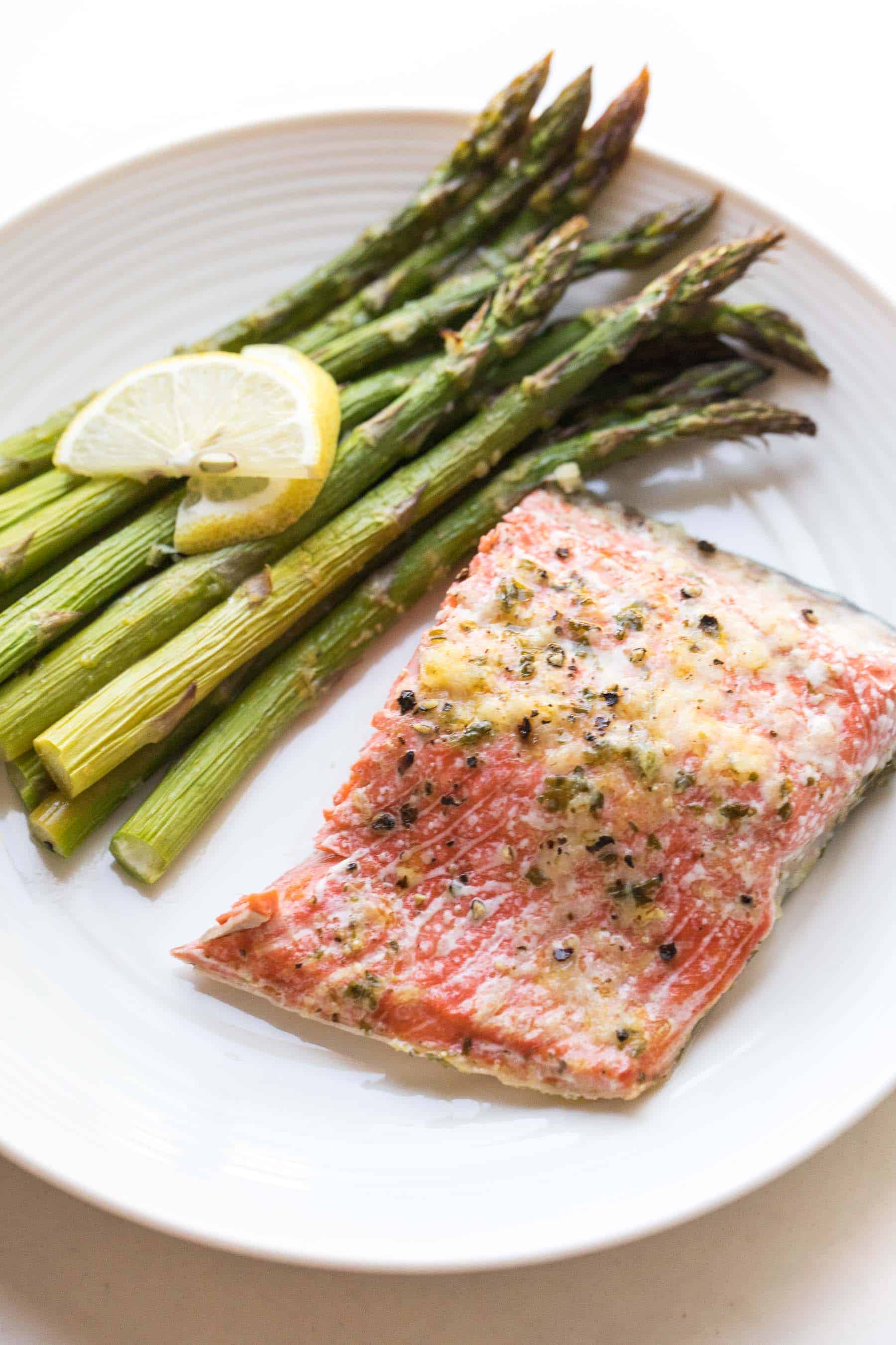 salmon and asparagus on a white plate