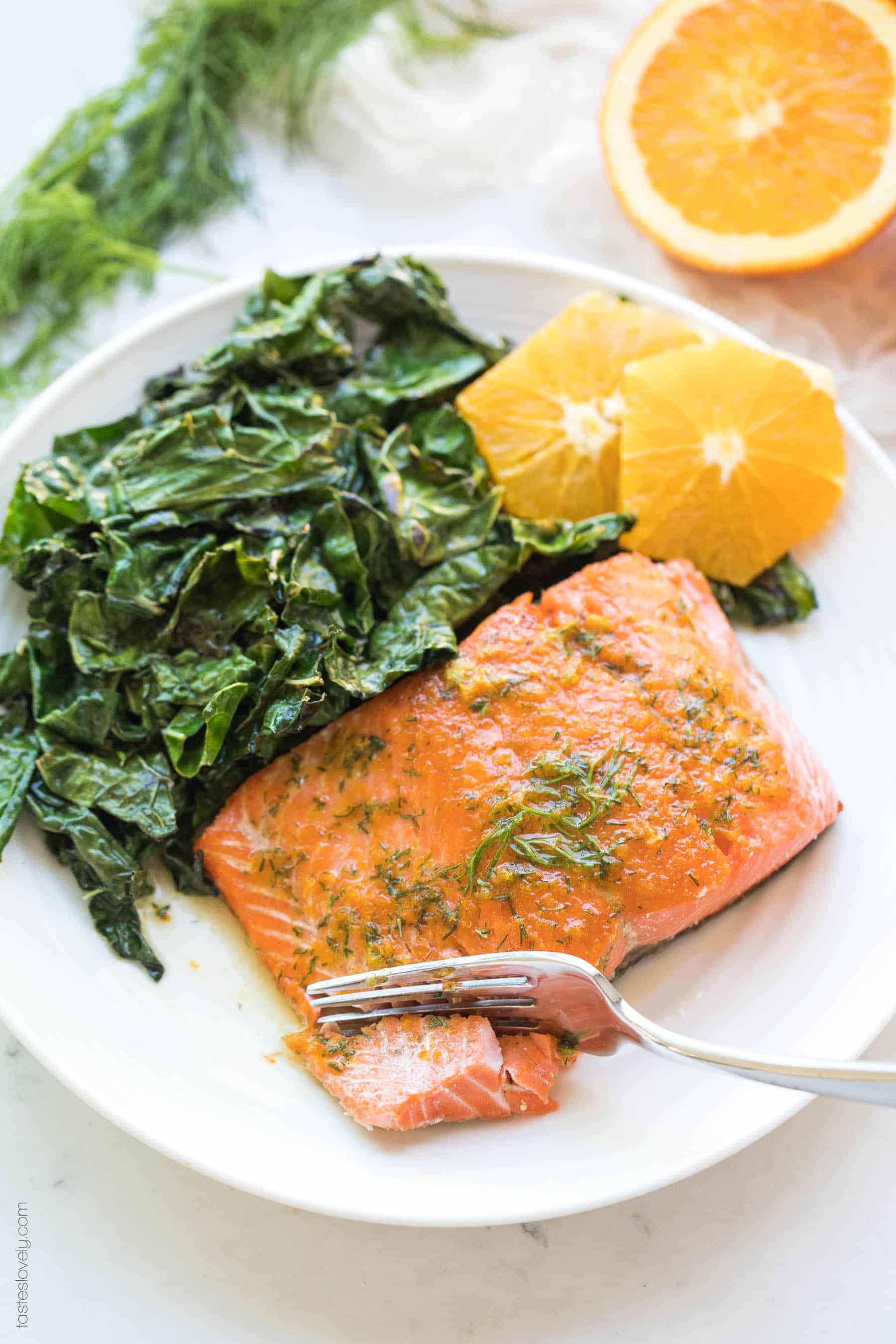 Salmon with oranges and kale and butter