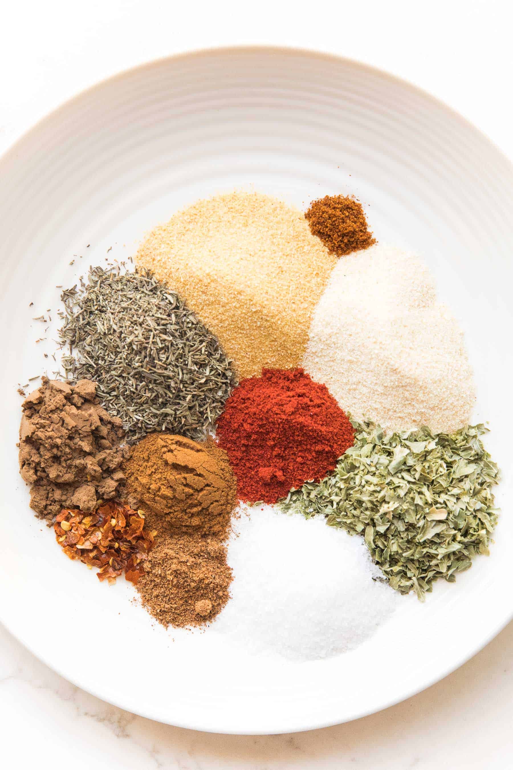 blend of spices for jamaican jerk seasoning on a white plate