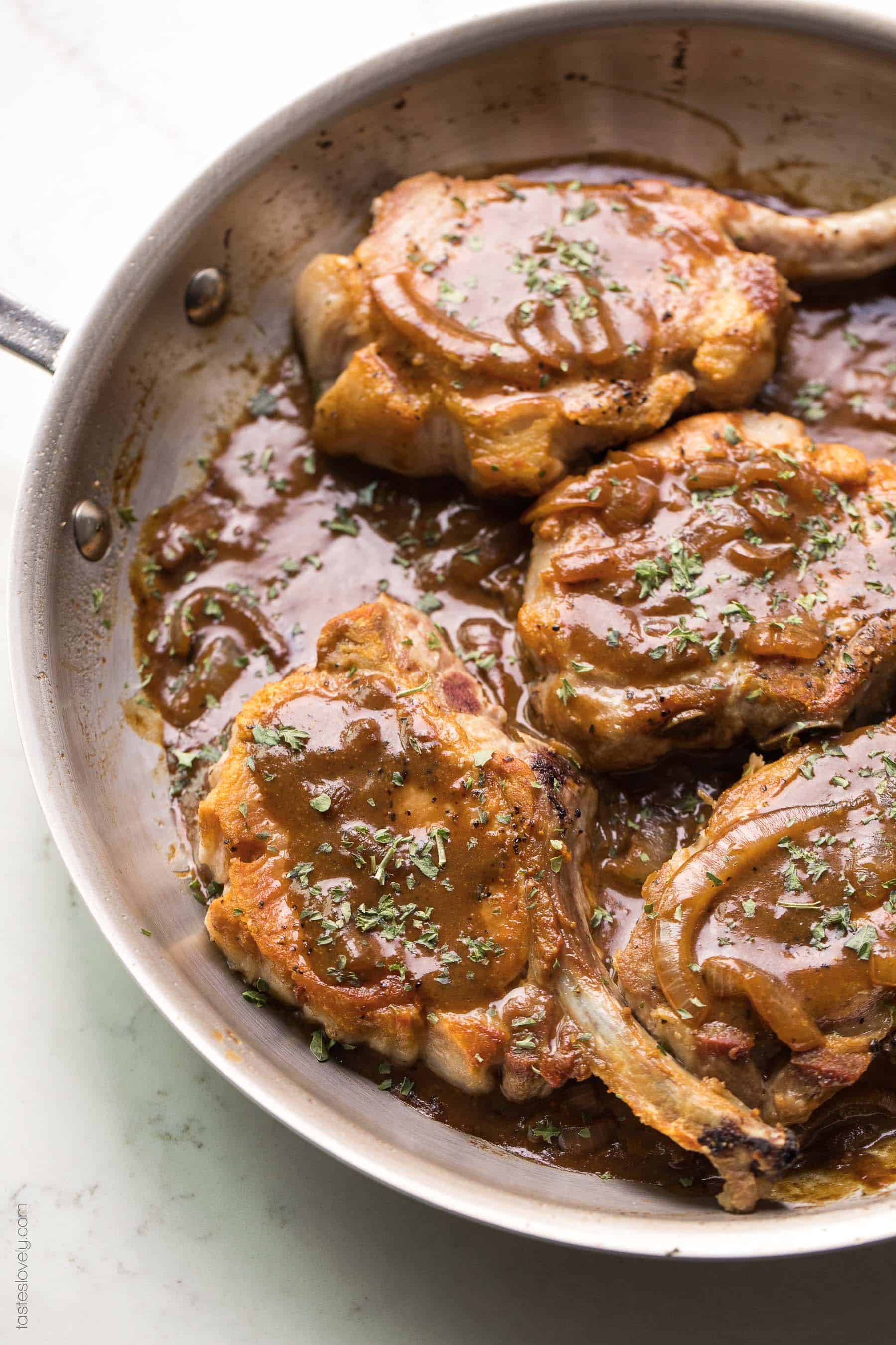 Pork chops in a brown balsamic mustard sauce in a skillet