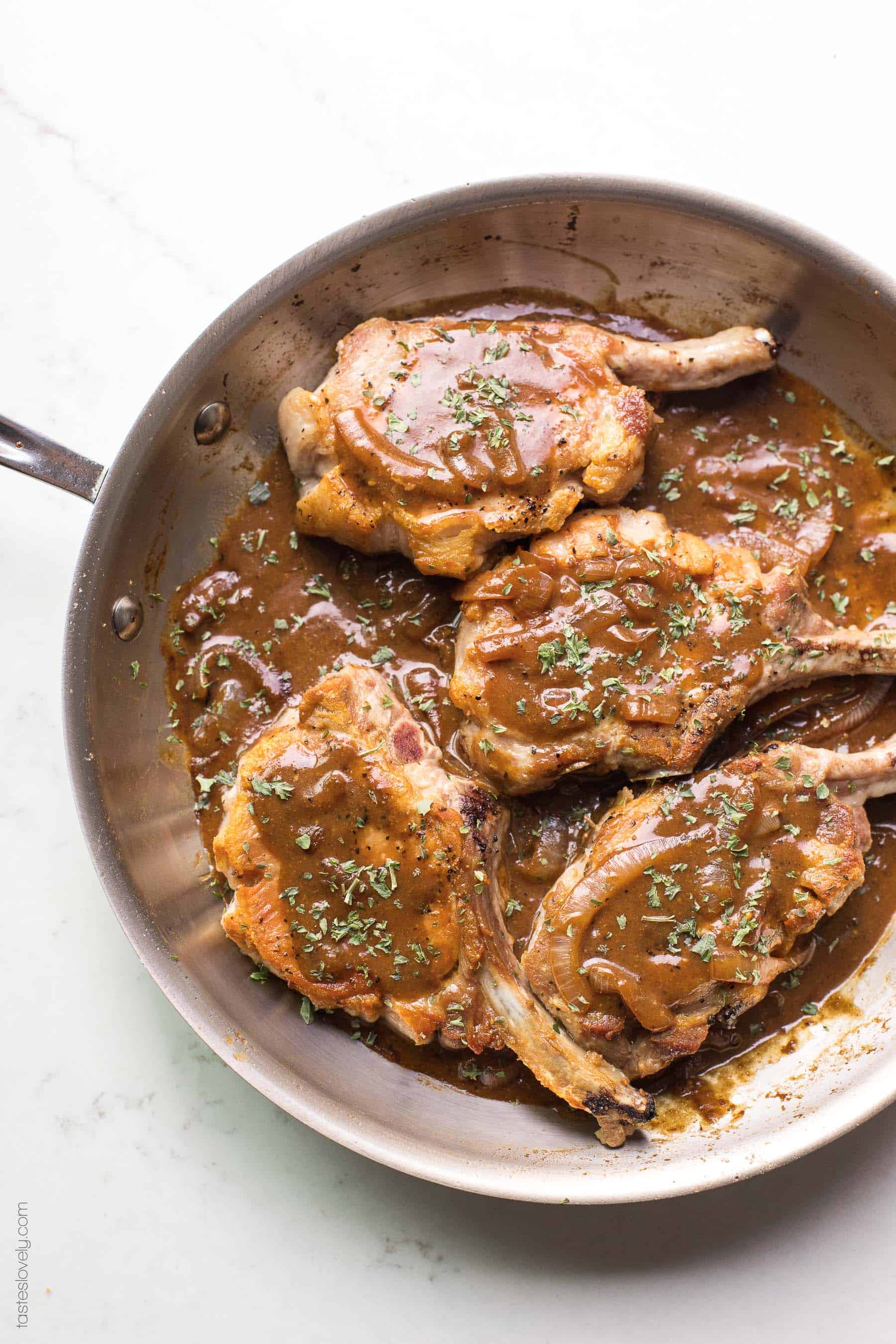 Pork chops in a brown balsamic mustard sauce in a skillet