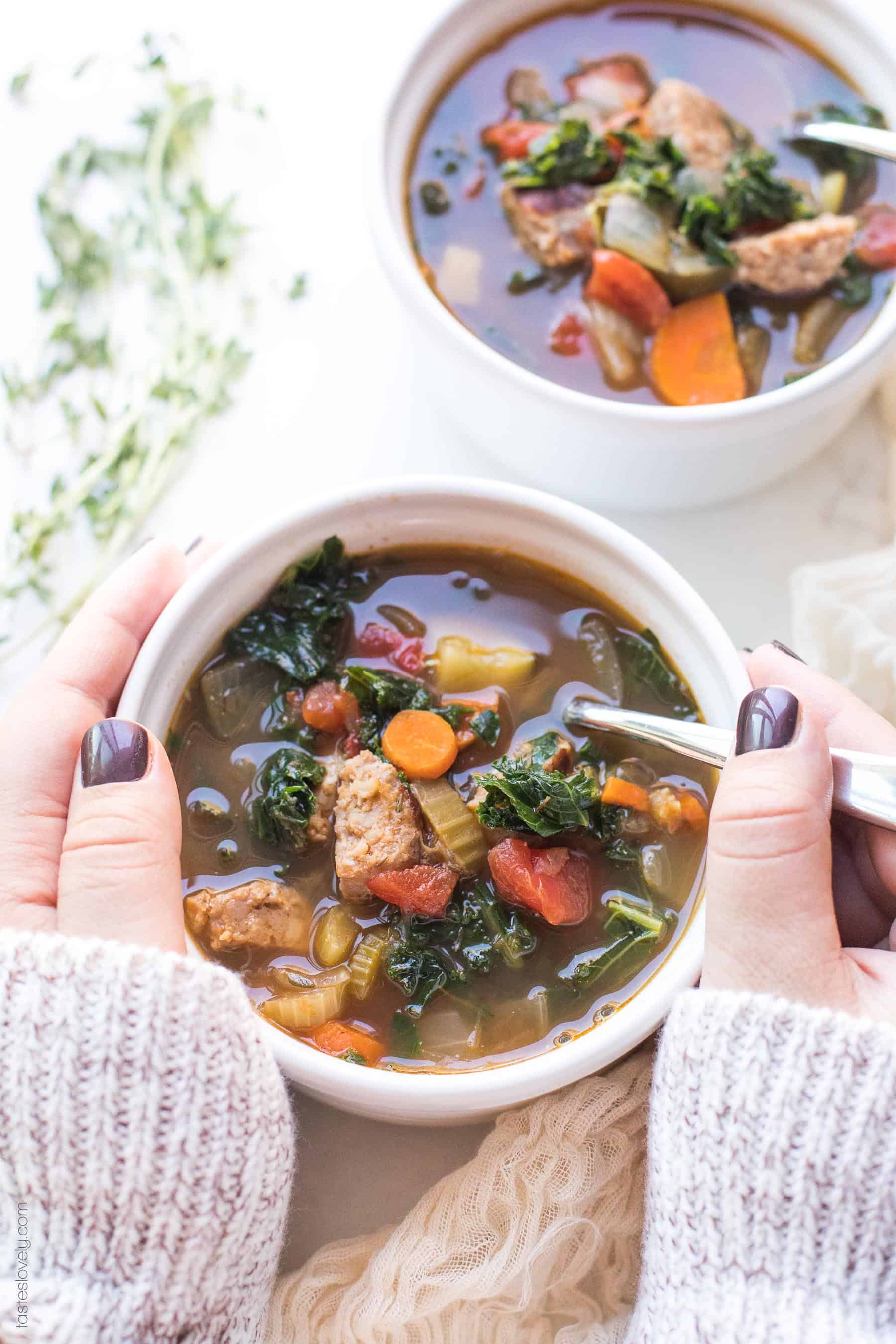 2 hands holding a bowl of soup