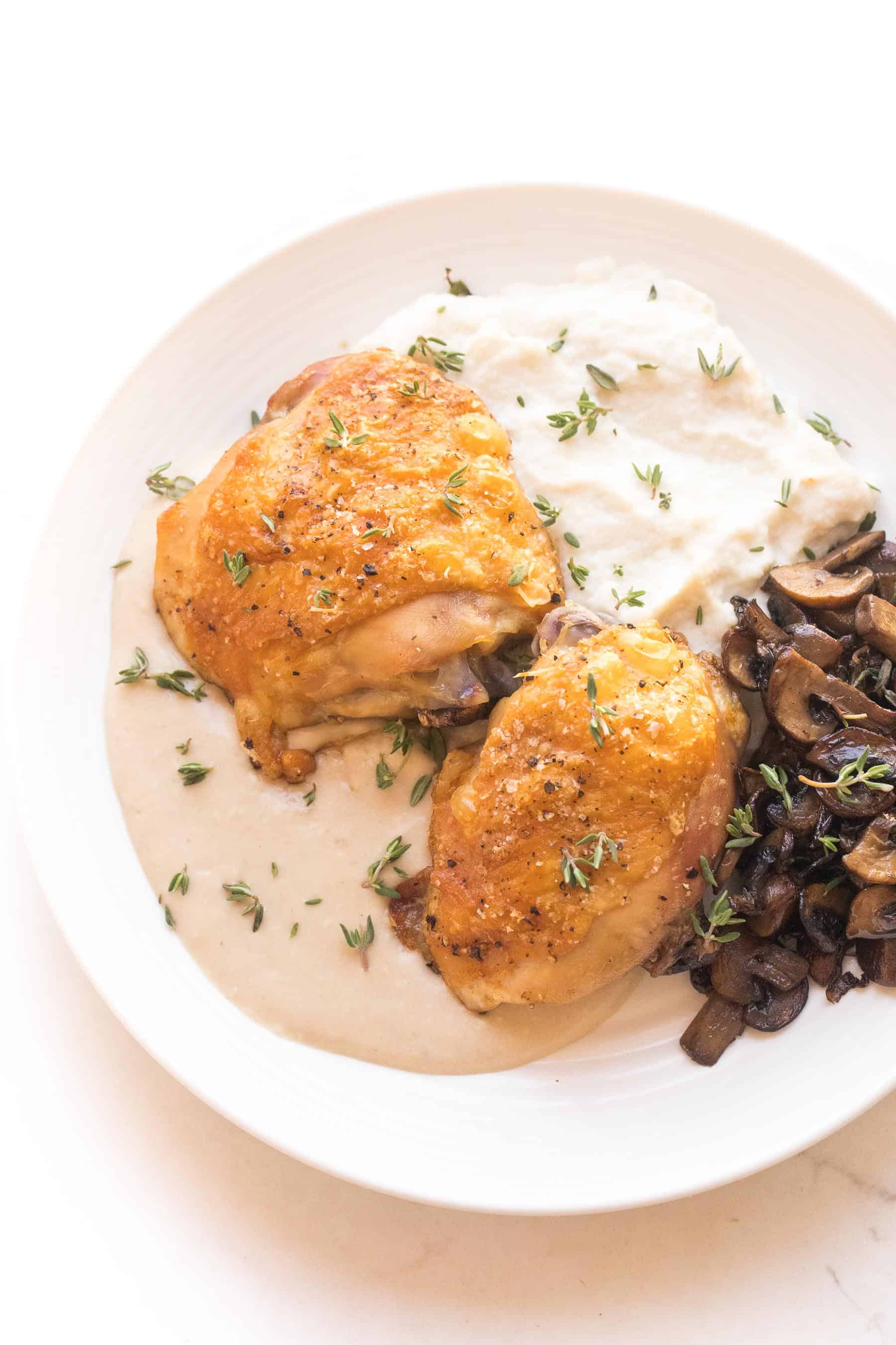 Crispy chicken thighs with mashed caulilfower + sauteed mushrooms with mustard sauce