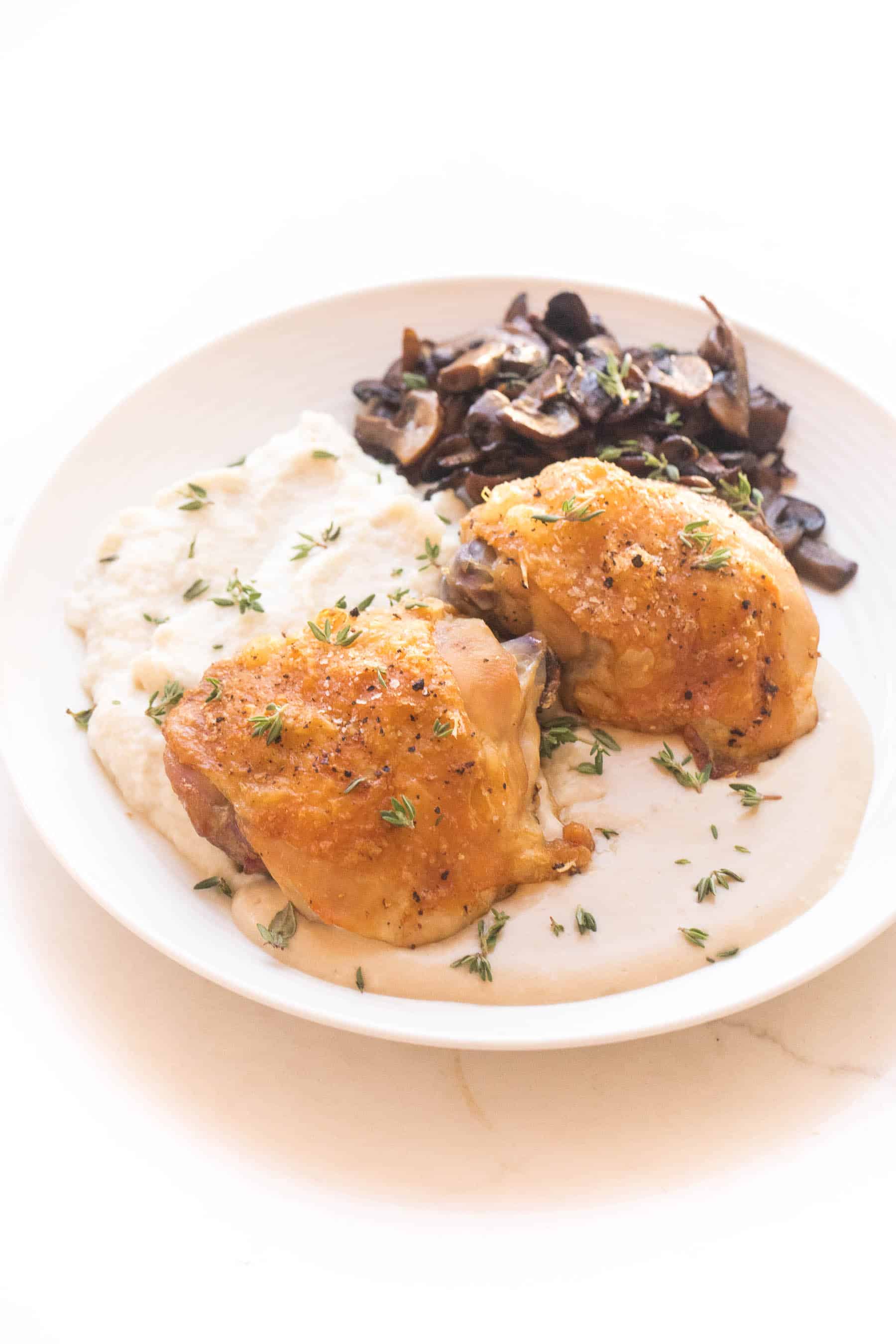 Crispy chicken thighs with mashed caulilfower + sauteed mushrooms with mustard sauce