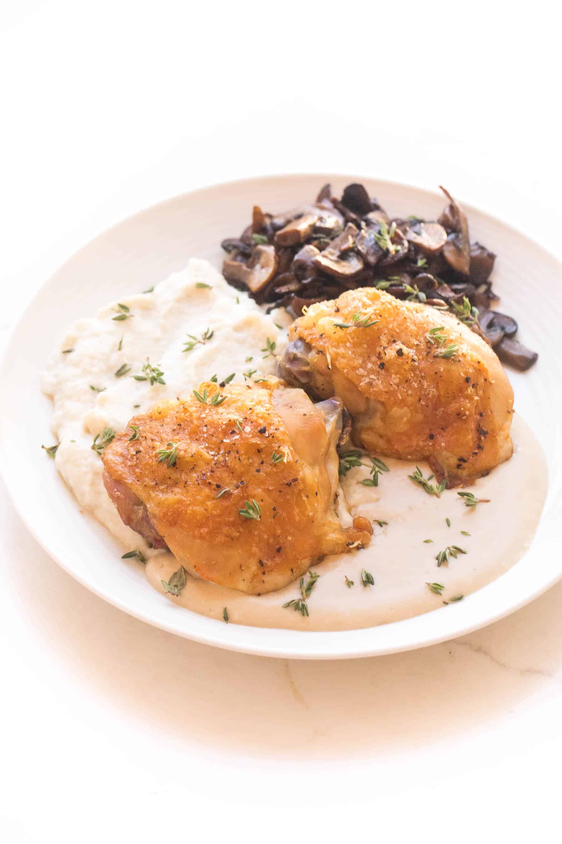 Crispy chicken thighs with mashed caulilfower + sauteed mushrooms with mustard sauce