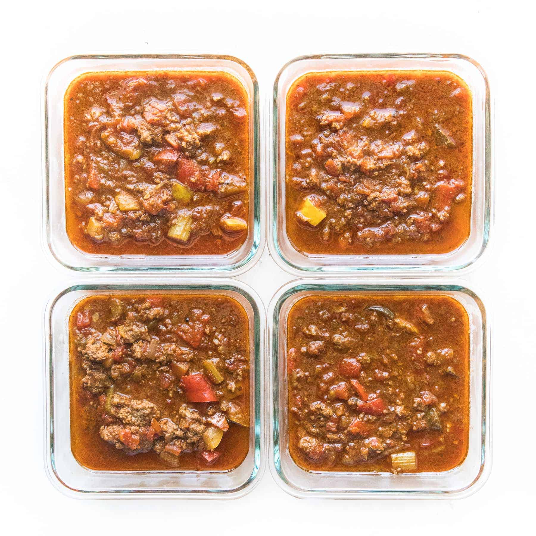 chili in meal prep containers on a white background