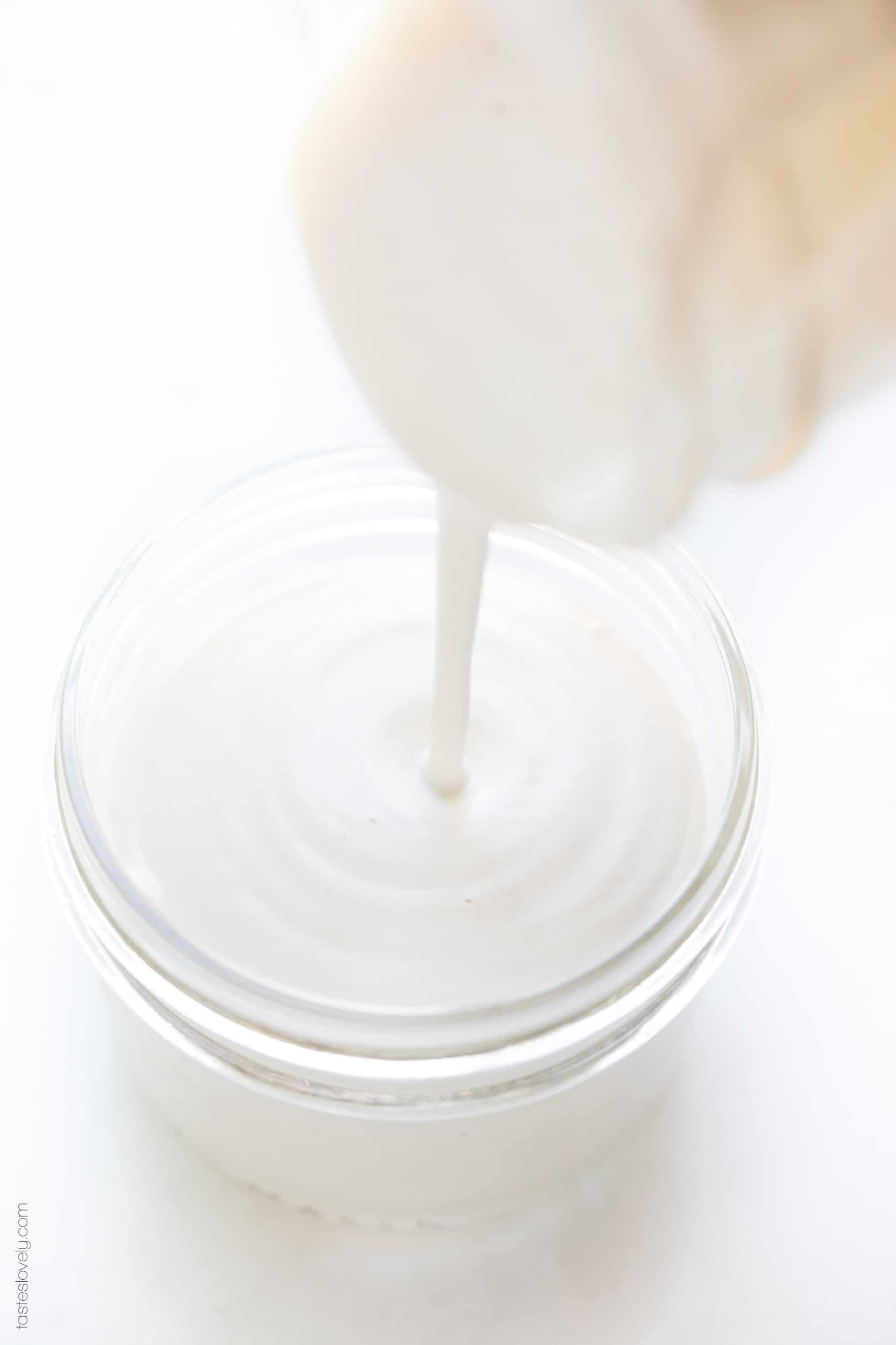 pouring cashew cream into a jar