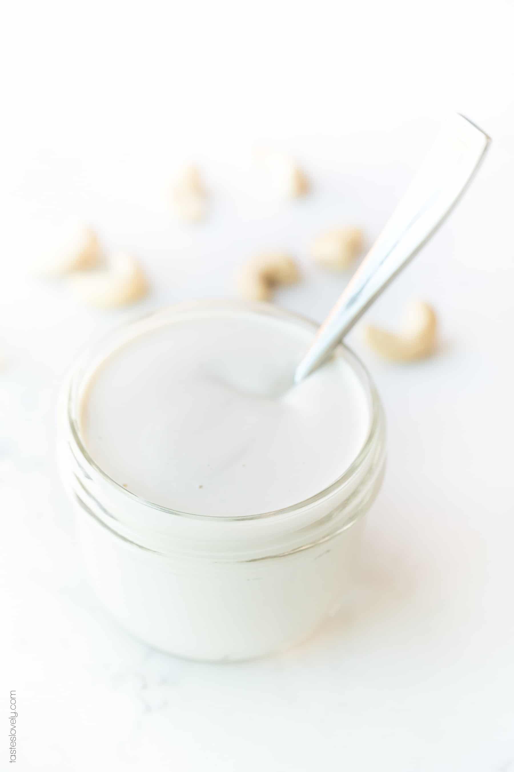 a jar of cashew cream with a spoon