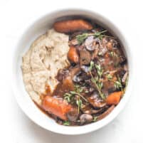 keto instant pot coq au vin with mashed cauliflower in a white bowl on a white background