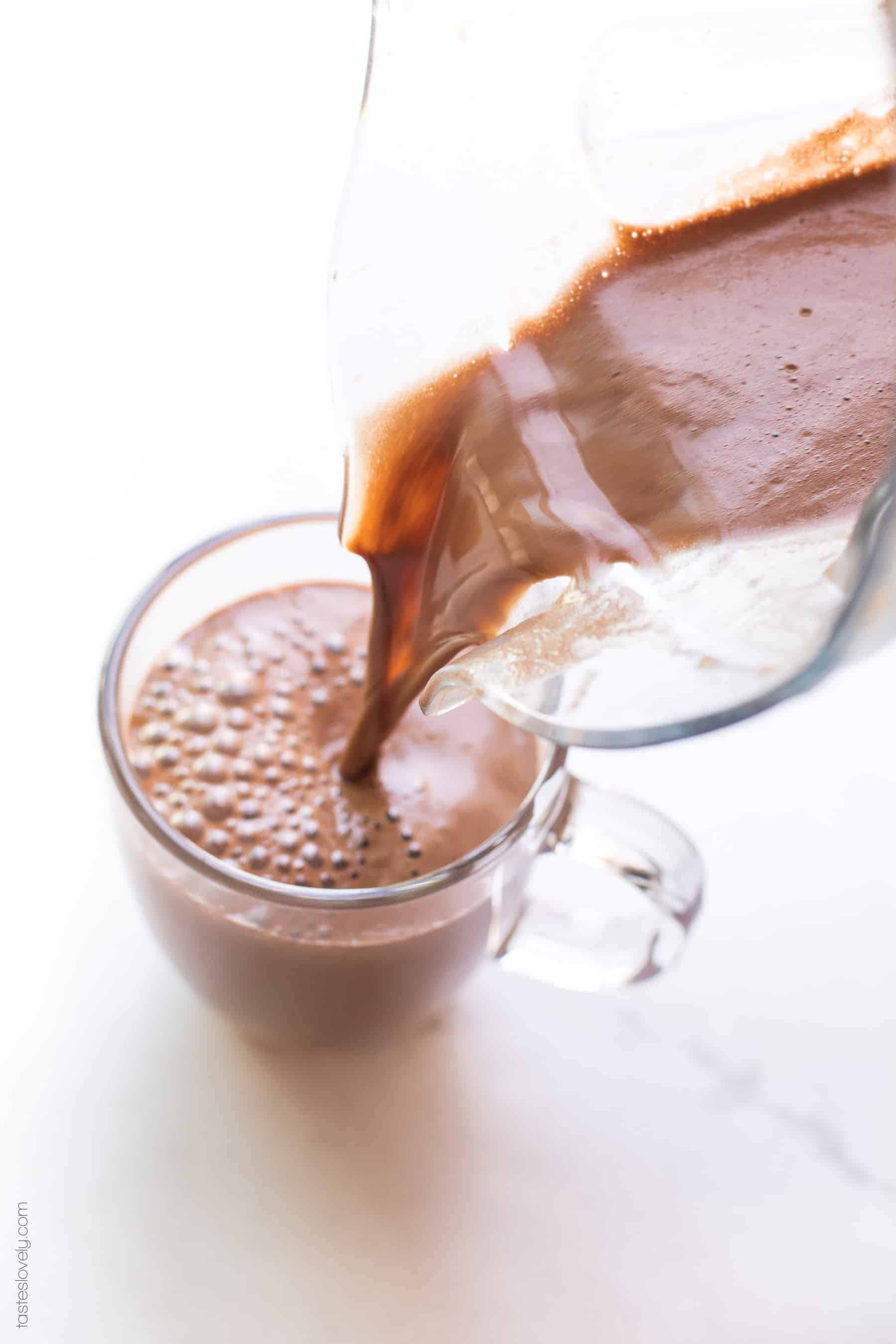 A mocha being poured into a coffee cup