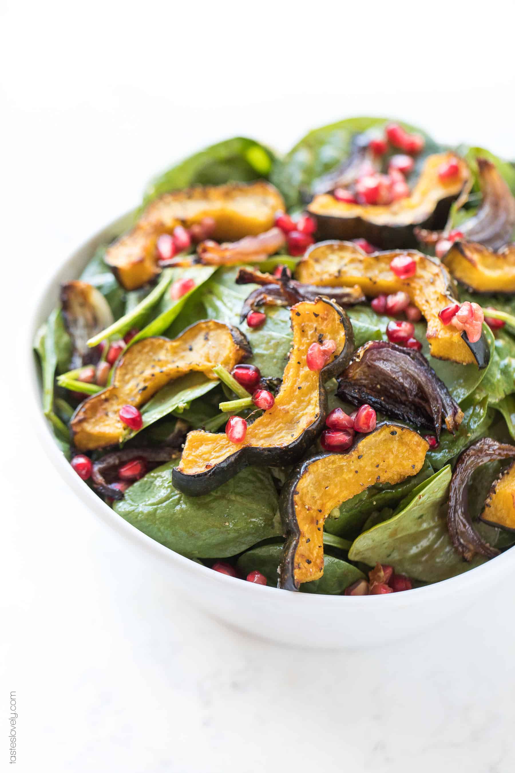 Spinach salad with roasted acorn squash, onions and pomegranates