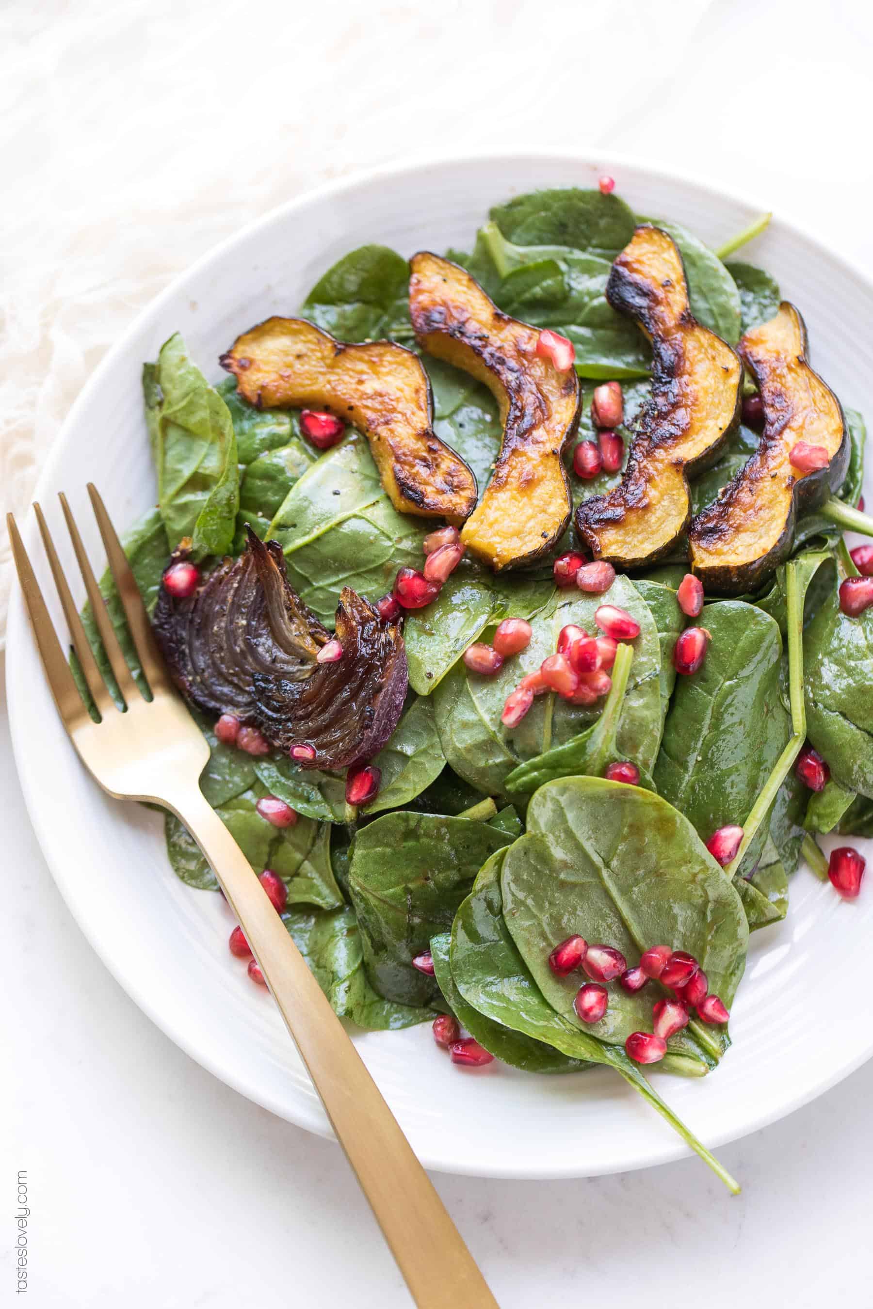 Spinach salad with roasted acorn squash, onions and pomegranates