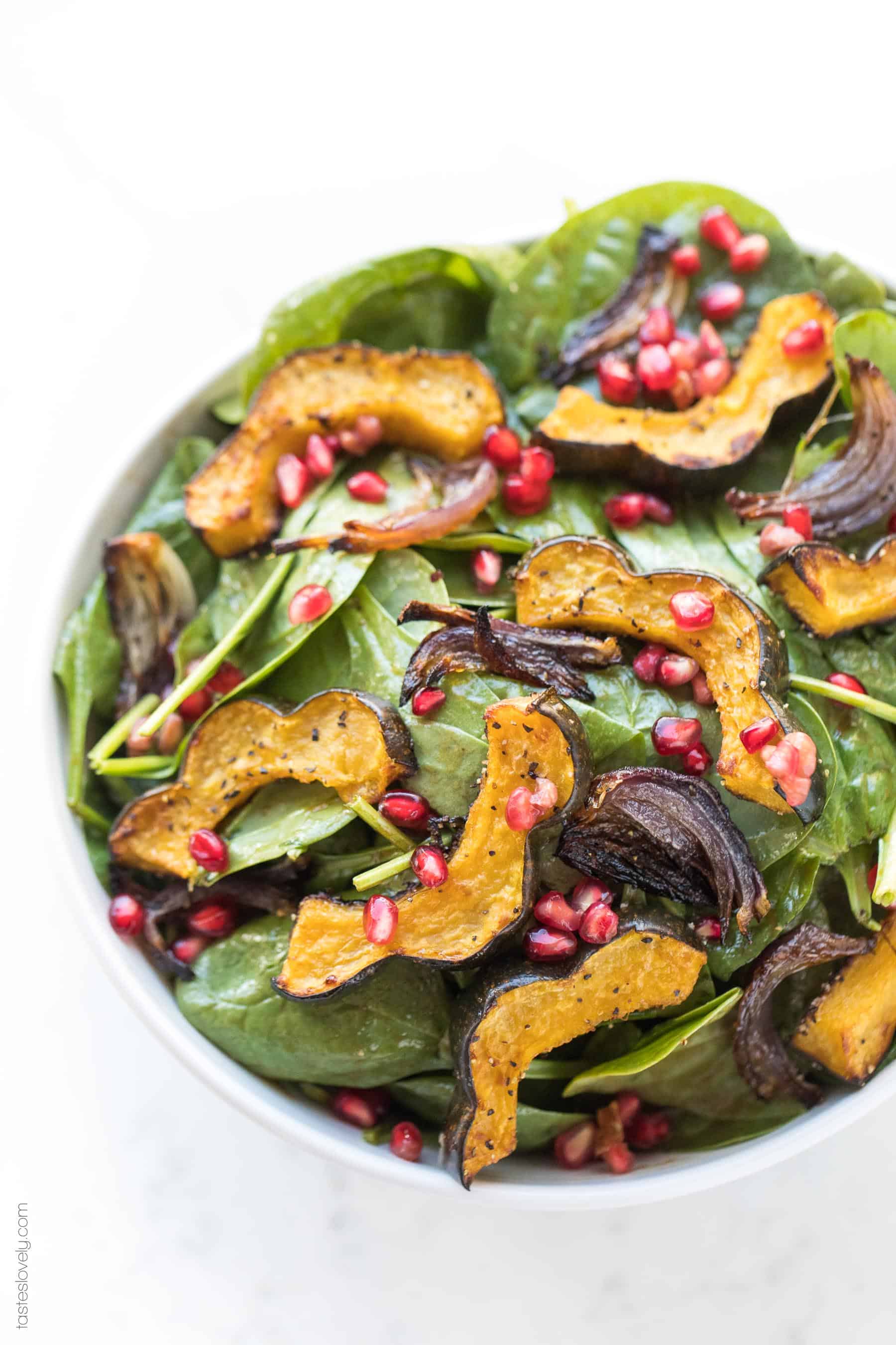Spinach salad with roasted acorn squash, onions and pomegranates