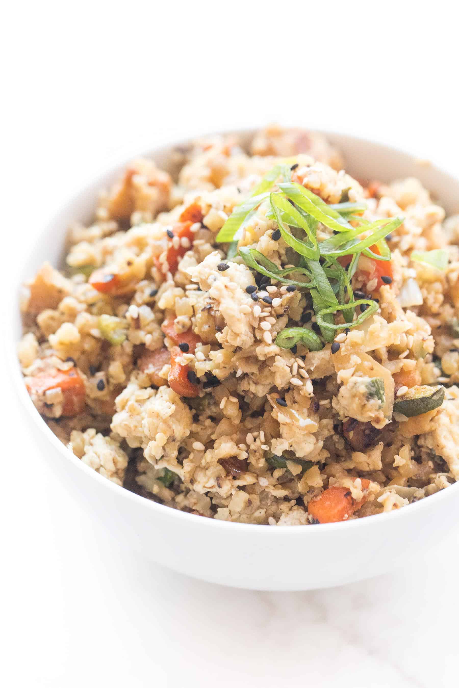 Whole30 + keto cauliflower fried rice in a white bowl