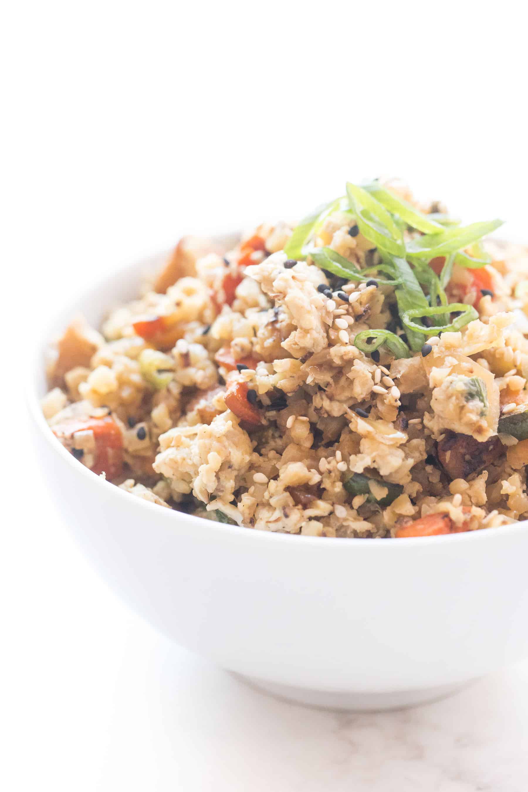 Whole30 + keto cauliflower fried rice in a white bowl