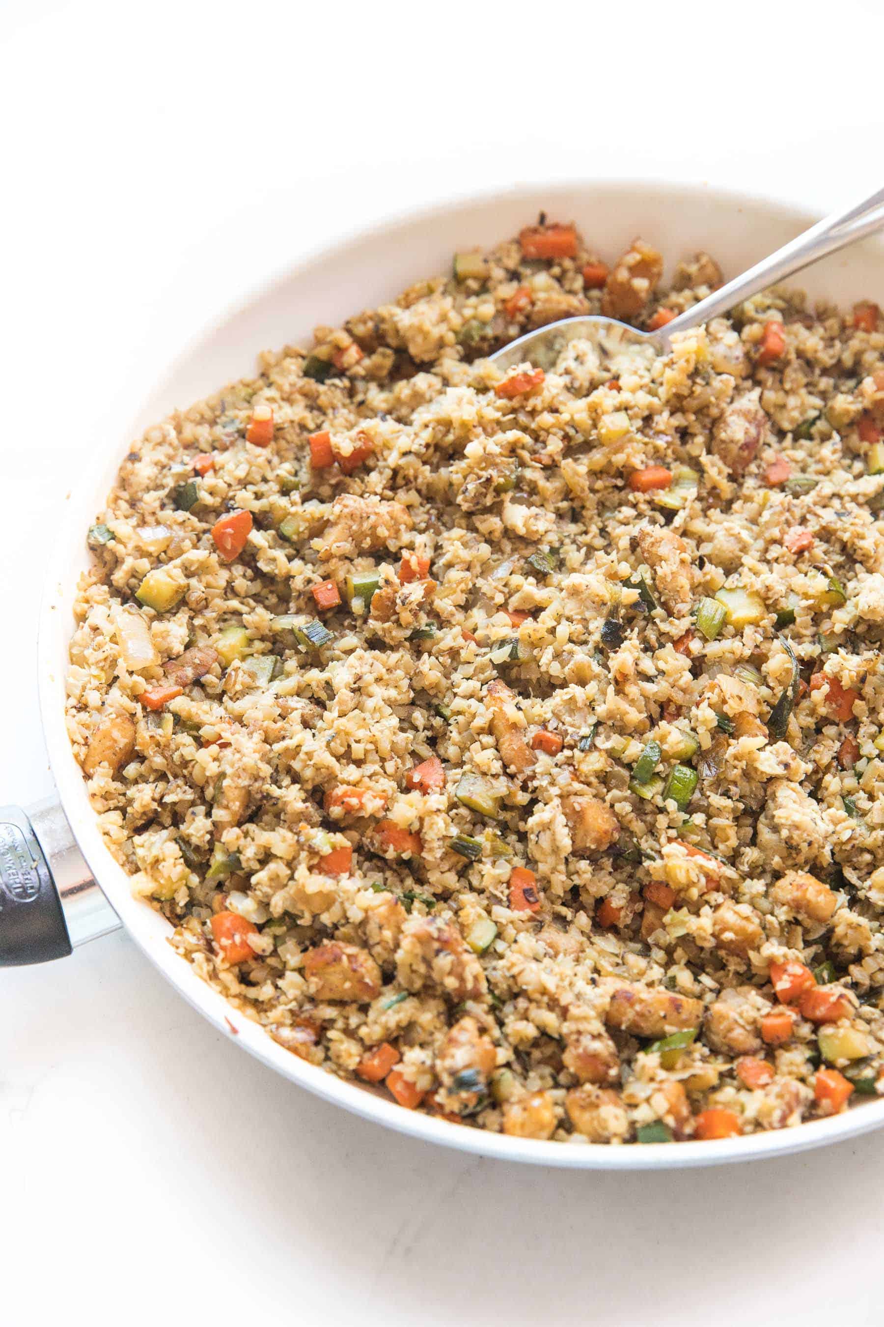 Whole30 + keto cauliflower fried rice in a white skillet