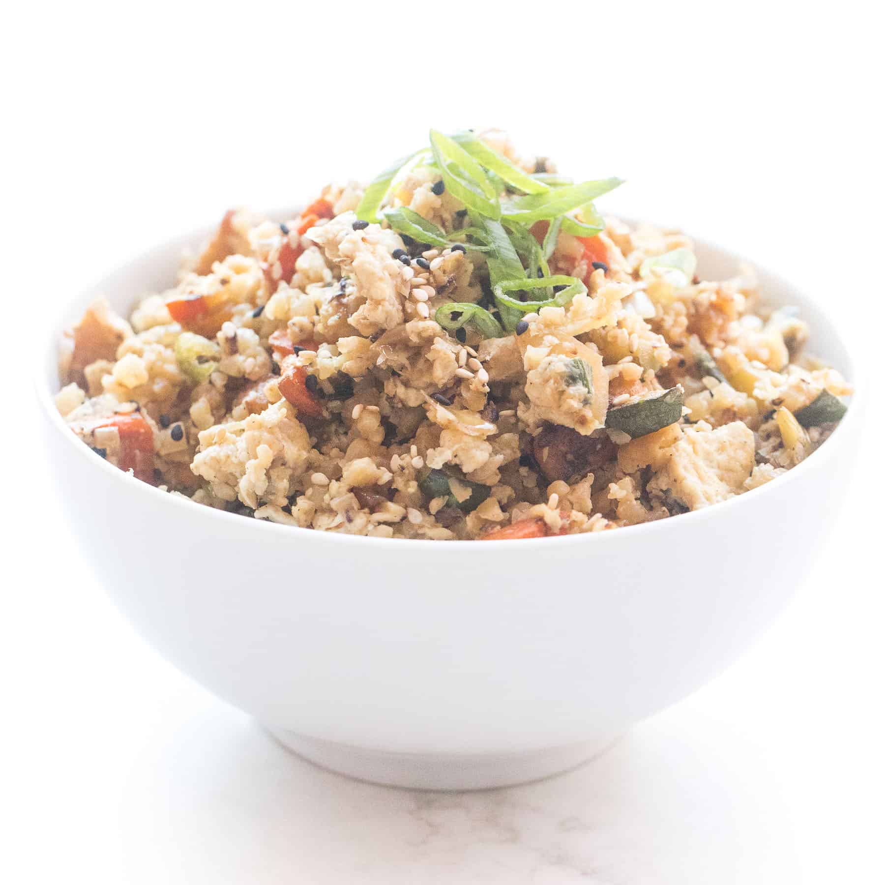 Whole30 + keto cauliflower fried rice in a white bowl