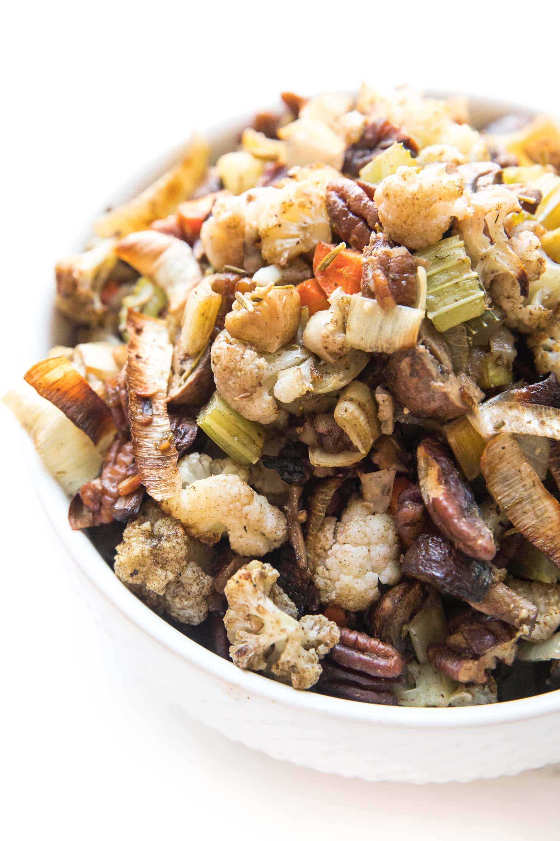 keto cauliflower stuffing made without bread in a white bowl with a white background