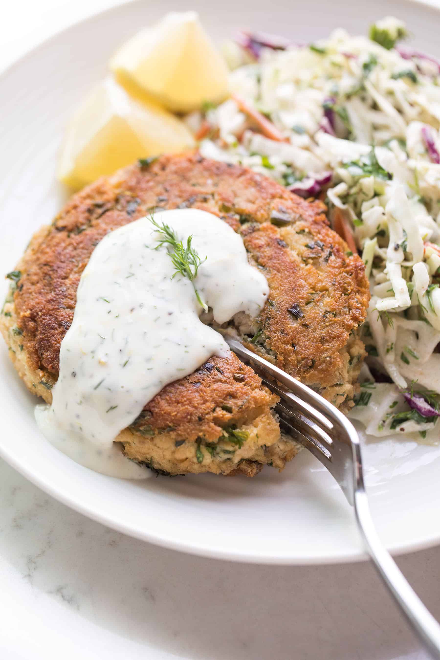 A fork cutting into keto salmon patties