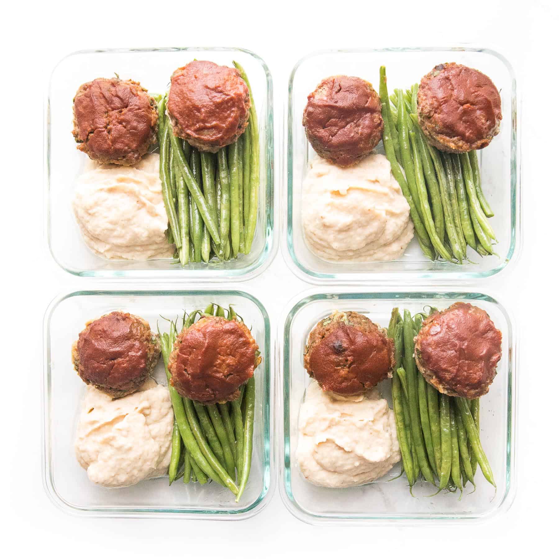 Mini meatloaf muffins topped with ketchup with green beans + mashed cauliflower + green beans in a meal prep container